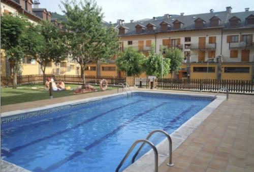 a large swimming pool in front of a building at CHECK-IN CASAS Casa Benas in Benasque