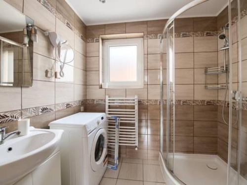La salle de bains est pourvue d'un lave-linge et d'un lavabo. dans l'établissement Domek w Pieninach, à Grywałd