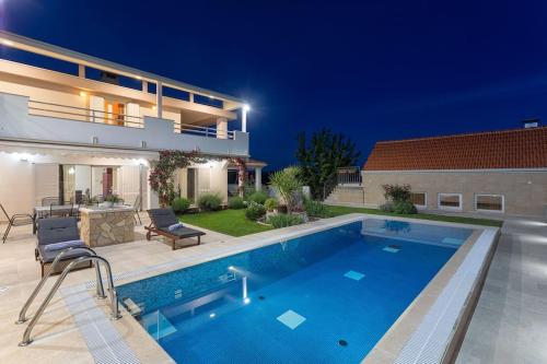 a swimming pool in the backyard of a house at Ferienhaus - Villa Delic - Makarska Exklusiv in Kreševo