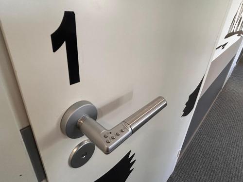 a lock on a door with a number one on it at ChillOut GuestHouse Lahti in Lahti