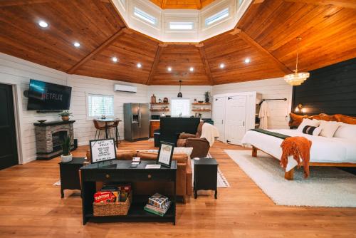 a bedroom with a bed and a living room at Romantic Gazebo Cottage w Hot Tub & Pond in Marshallville
