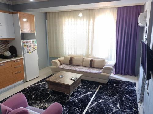 a living room with a couch and a table at Egepar Rezidance Apart in Buca