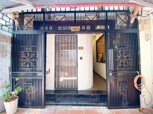 an entrance to a building with black and white doors at A Little Saigon in Ho Chi Minh City