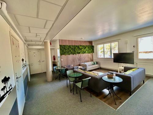 a living room with a couch and a table at ChillOut GuestHouse Lahti in Lahti