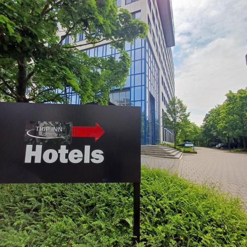 a sign in front of a building with a hotel at Trip Inn Hotel Düsseldorf Neuss in Neuss