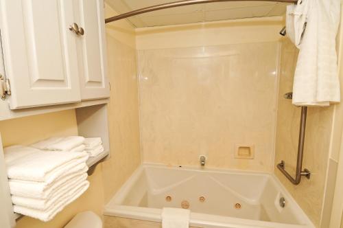 a bathroom with a tub and some towels at Holiday Sands South in Myrtle Beach