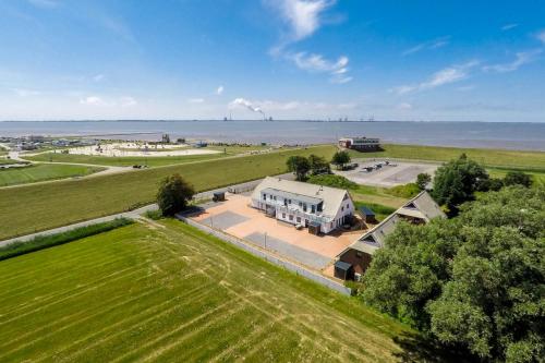 an aerial view of a farm with a large building at Ferienhaus 14 "Gut Tossens" in Tossenserdeich