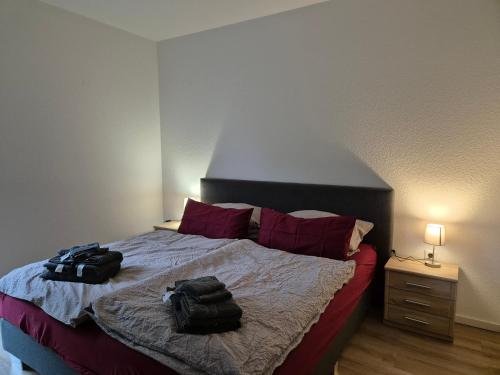 a bedroom with a bed with two bags on it at Ferienwohnung Hennemann in Schmallenberg