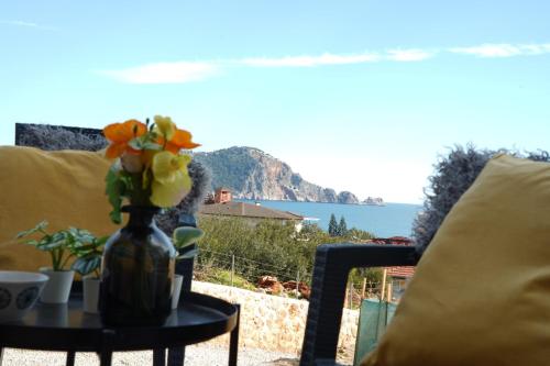 a vase of flowers on a table with a view at Renka Holidays Houses and Caravans in Alanya
