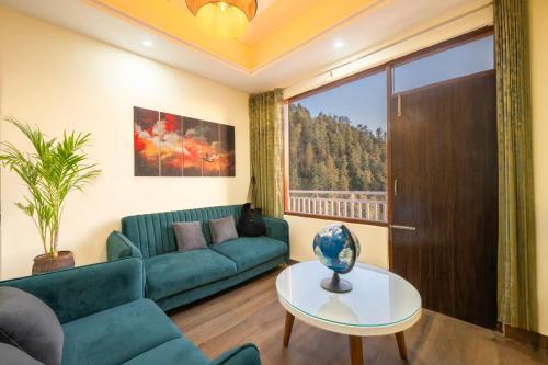 a living room with a couch and a table at Saanjh - The Musical Sunset in Shimla