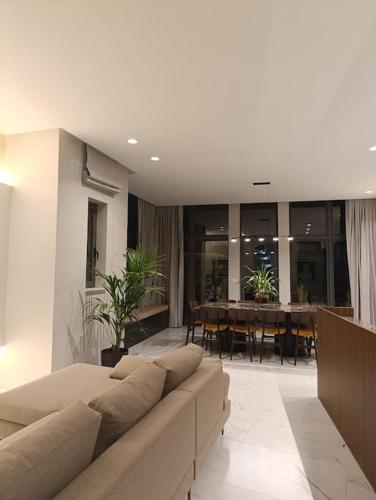 a living room with a couch and a dining room at Villa Vera with private pool near Valletta in Tal-Pietà