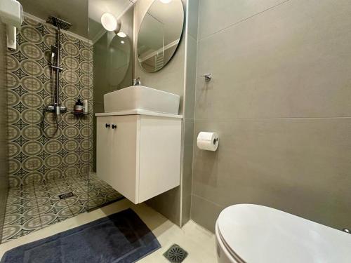 a bathroom with a toilet and a sink and a mirror at The blue house Athens in Athens