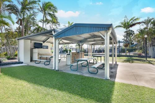 a pavilion with picnic tables and benches in a park at Tasman Holiday Parks - Fraser Coast in Hervey Bay