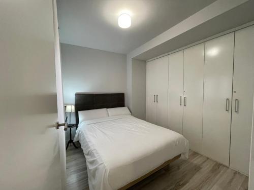 a bedroom with a white bed and white cabinets at Casa Alberto 1 drch in Tudela