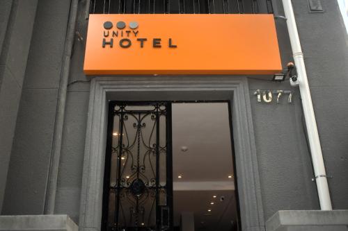 an orange sign above a door to a hotel at Unity Hotel - Paulista - SP in Sao Paulo