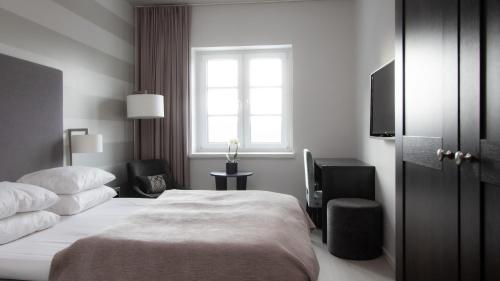 a hotel room with a bed and a window at Wilhelmsen House in Tønsberg