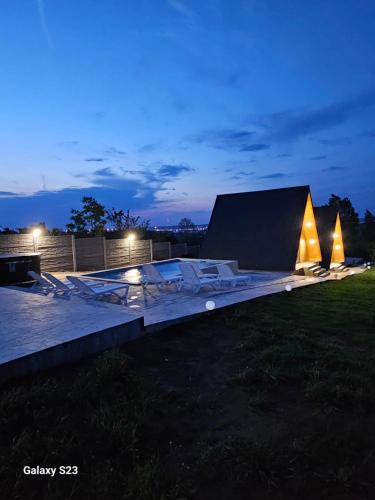 a night view of a building with lights on it at Wild A-frame in Baile Felix