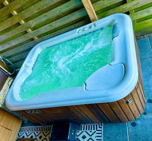 a blue bath tub sitting on top of a floor at Tiny house with sauna & jacuzzi near Amsterdam in Vijfhuizen