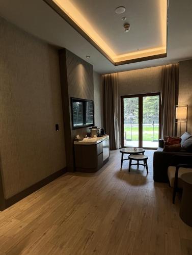 a living room with a couch and a table at Swissotel Uludag Bursa in Bursa