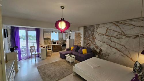 een woonkamer met een paarse bank en een tafel bij Airport Residence 3 in Otopeni