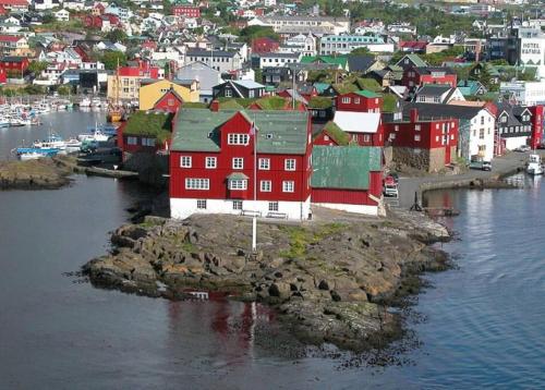 a group of houses on a small island in the water at 3 BR home for 9 guests in a quiet neighborhood in Tórshavn