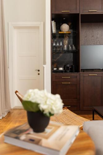 a vase of flowers on a table in a living room at Boutique Hotel Stari Grad in Dubrovnik