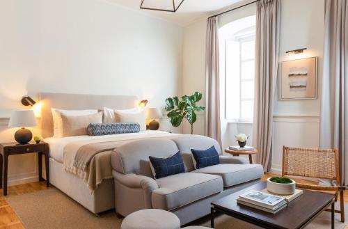 a bedroom with a large bed and a couch at Boutique Hotel Stari Grad in Dubrovnik