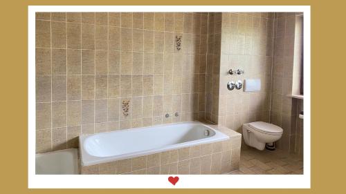 een badkamer met een bad en een toilet bij Berghupferl-Alm - do legst di nieda in Flintsbach am Inn