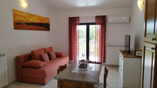 a living room with a couch and a table at Villa "Pied-à-terre" Residence & Spa in Umag