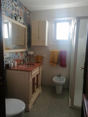 a bathroom with a sink and a toilet at PASEO MARITIMO in Barbate