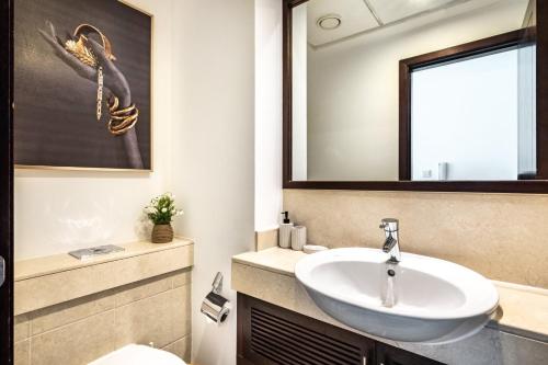 a bathroom with a sink and a mirror at Stunning 1-Bedroom Apartment with full Burj Khalifa View - 5-min walk to Dubai Mall in Dubai