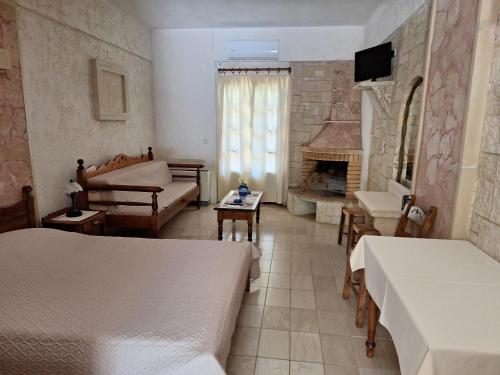 a bedroom with two beds and a fireplace at Mountain Vista Resort in Roústika