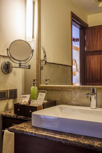a bathroom with a sink and a mirror at The Grand Dragon Ladakh in Leh