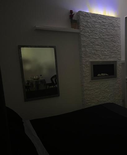 a living room with a fireplace and a mirror at Palese Profumo di Mare in Santo Spirito