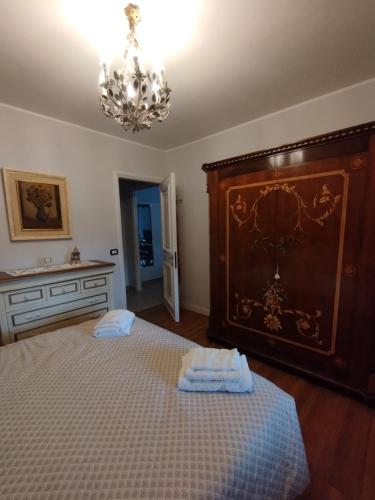 a bedroom with a large bed and a chandelier at Patty's House in Gavignano