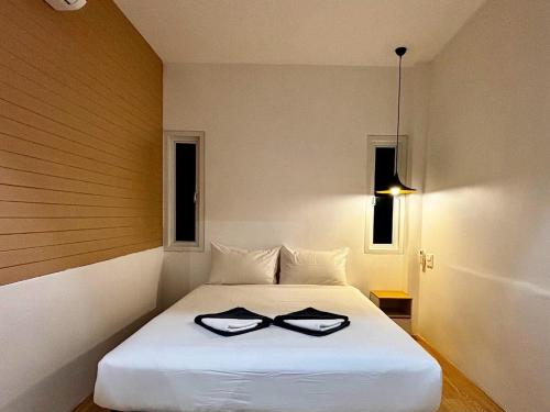 a bedroom with a bed with two bowties on it at Minimal2 MaeHaad in Koh Tao
