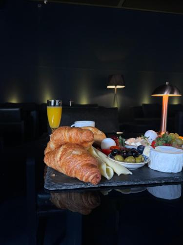 a tray with a loaf of bread and a plate of food at Black Hotels Köln in Cologne