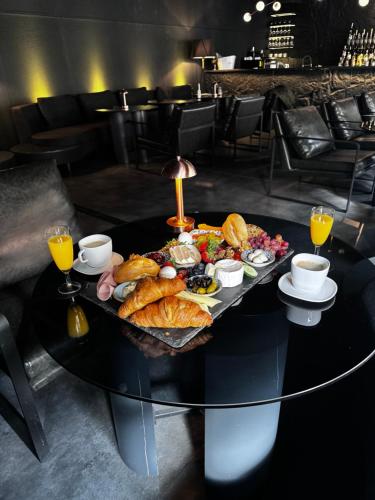 a table with a tray of food on it at Black Hotels Köln in Cologne