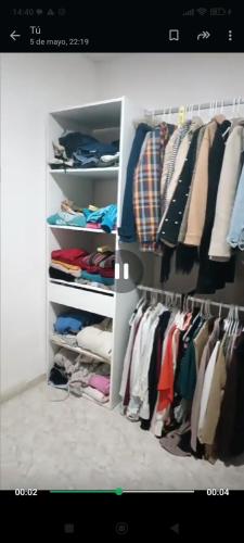 a closet filled with lots of clothes at Piso en Estación de buses in Granada