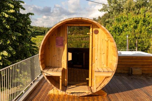 a wooden tub sitting on a wooden deck at Peso Village in Amarante