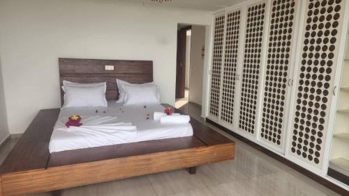 1 dormitorio con 1 cama grande con sábanas blancas en BEACHFRONT APPARTMENT, en Kribi