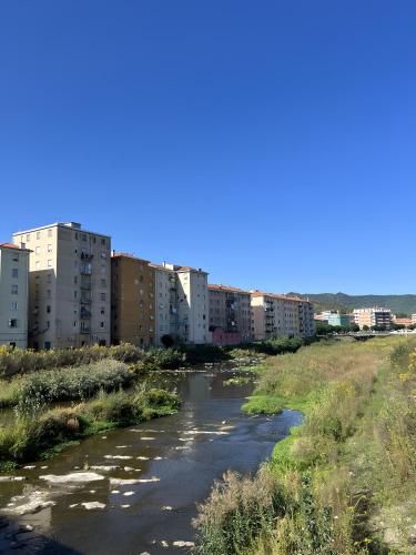a river in the middle of a city with buildings at Dimora del borgo pittoresco in Cairo Montenotte