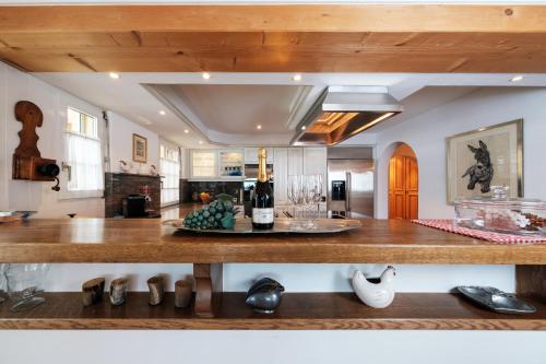a kitchen with a counter with wine bottles on it at Heart of Davos apartments in Davos