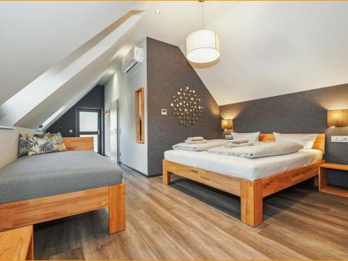 a bedroom with two beds and a staircase at Hotel Landlust St. Martin in Sankt Martin