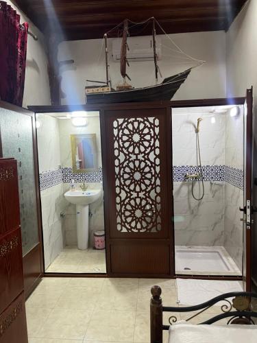 a bathroom with a shower and a toilet and a sink at Riad el wazania in Rabat