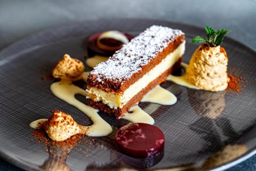 a plate with a piece of cake and some desserts at Bodensee-Hotel Sonnenhof in Kressbronn am Bodensee