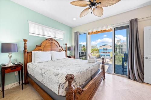 a bedroom with a bed and a large window at A Somewhere is Here by Beachside Management in Siesta Key