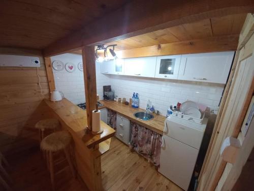 a small kitchen with a sink and a refrigerator at U Dziadka 