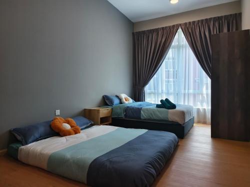 a bedroom with two beds and a large window at Kuantan- Cozy Little Home @Mahkota Valley By VHOME in Kuantan