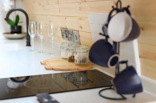 a kitchen counter with glass jars on a counter top at Primrose Glamping Pods in Ingleton 
